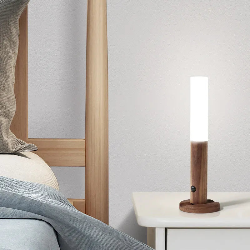 Smart sensor LED desk lamp in solid wood and organic glass with automatic motion activation.