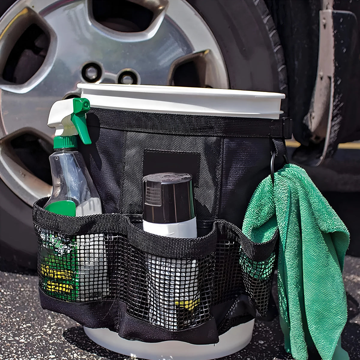 Black cylindrical polyester storage bag fitted onto a 5-gallon bucket for holding car wash tools and fishing gear.