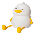 Chubby silicone night light with LED glow functioning as a desktop phone holder