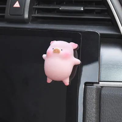 A cute resin cartoon pig figurine car dashboard decoration on a grey background.