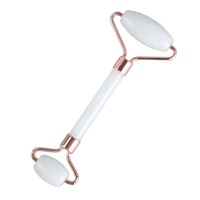 Natural white jade facial roller and gua sha scraping board set on a white background.