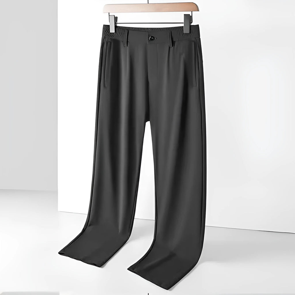 Man wearing black Ice Silk straight loose fit casual trousers with an elastic waistband.