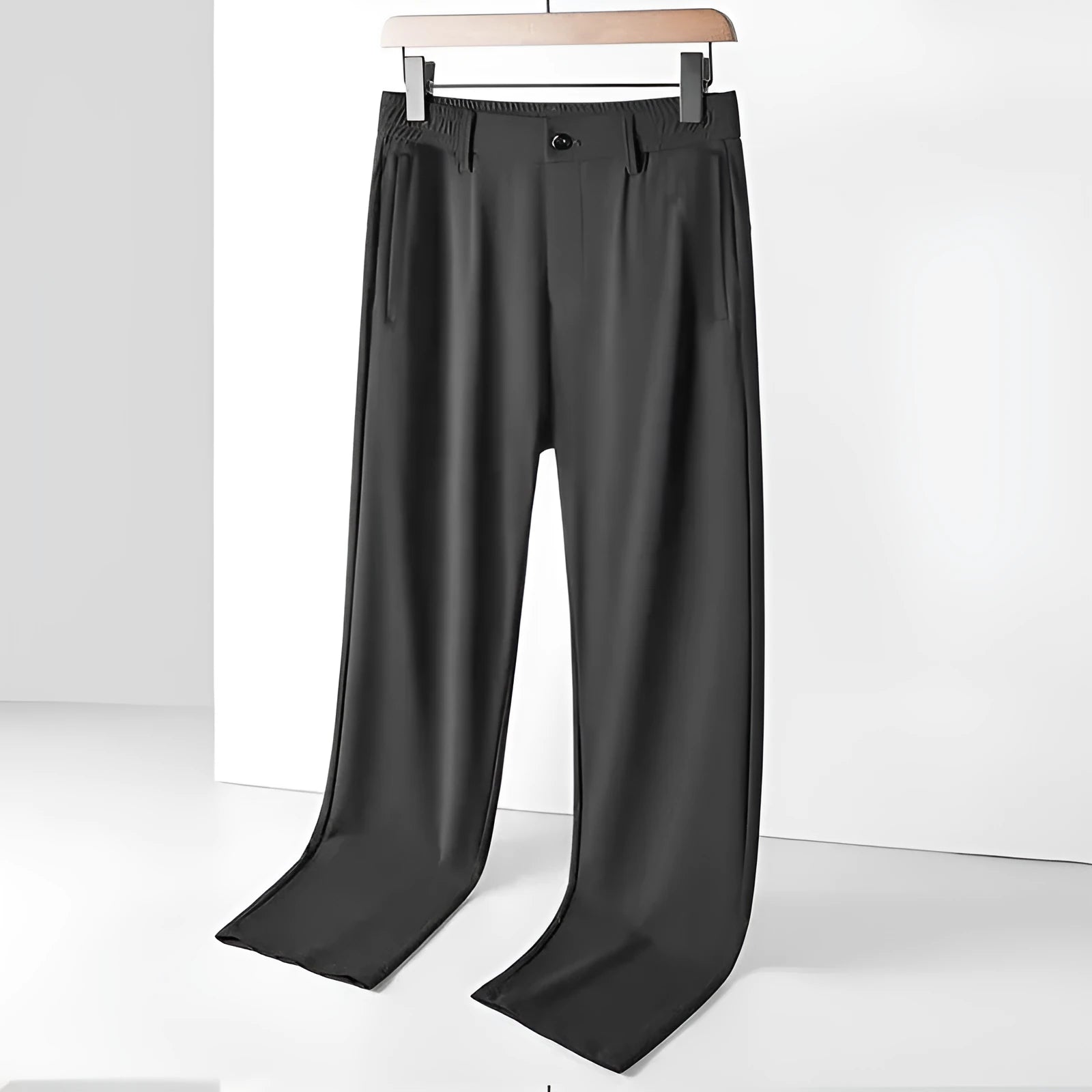 Man wearing black Ice Silk straight loose fit casual trousers with an elastic waistband.