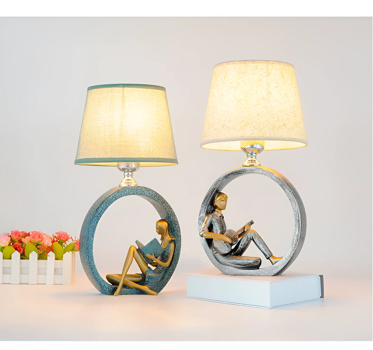 Blue resin reading girl table lamp with cloth shade on a table, 20x39.8cm