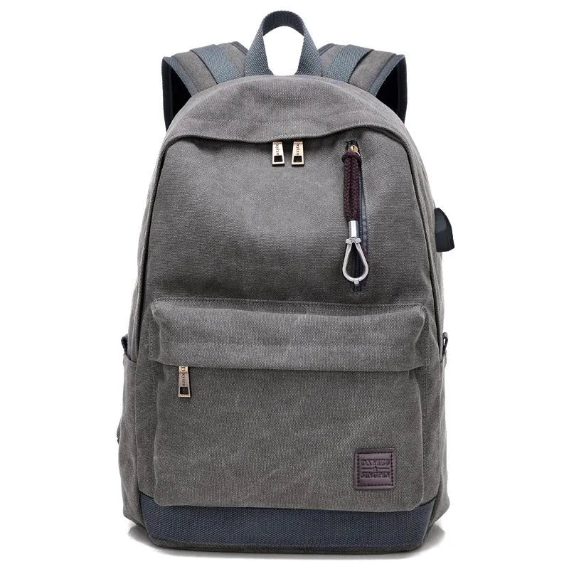 Canvas backpack with USB charging port shown in grey, featuring a laptop sleeve and front zipper pocket.