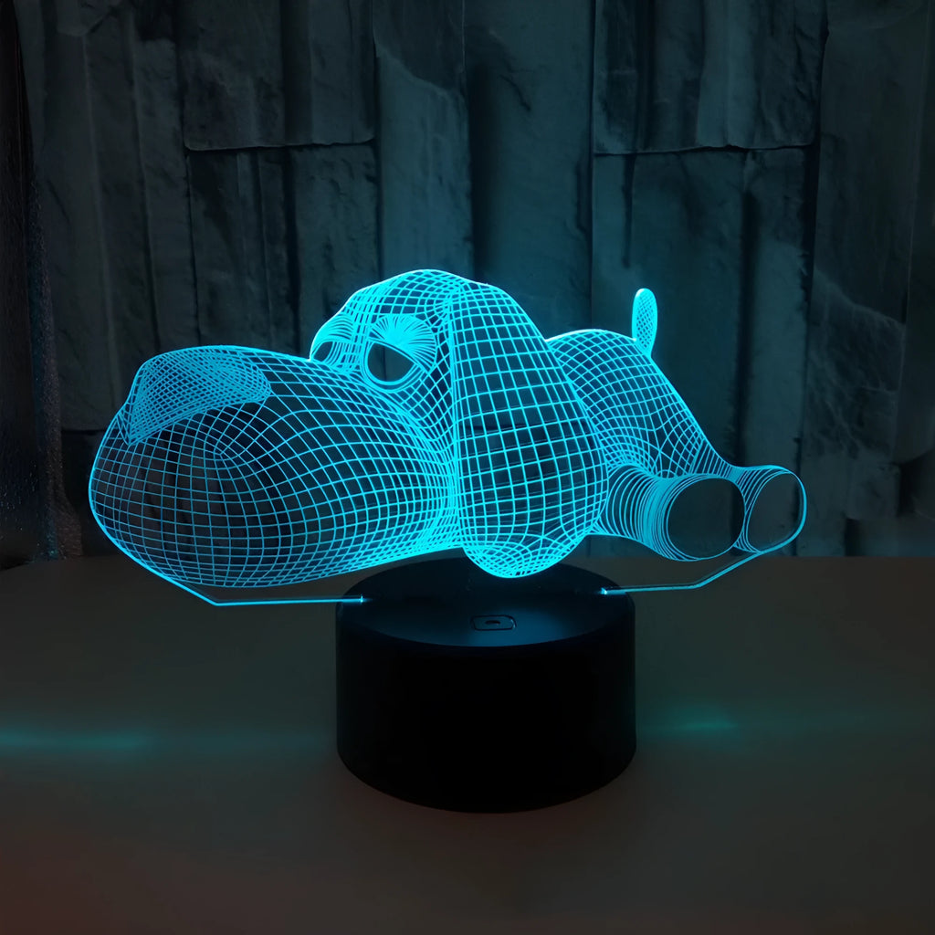 3D illusion dog lamp glowing in multiple colours on a desk with USB cable