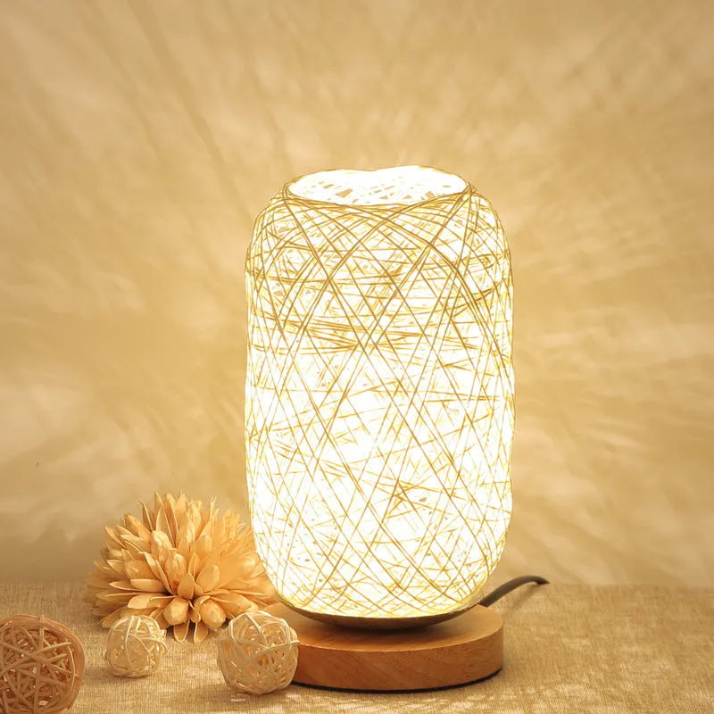 Brown hemp rope desk lamp with spherical shade on circular wood base