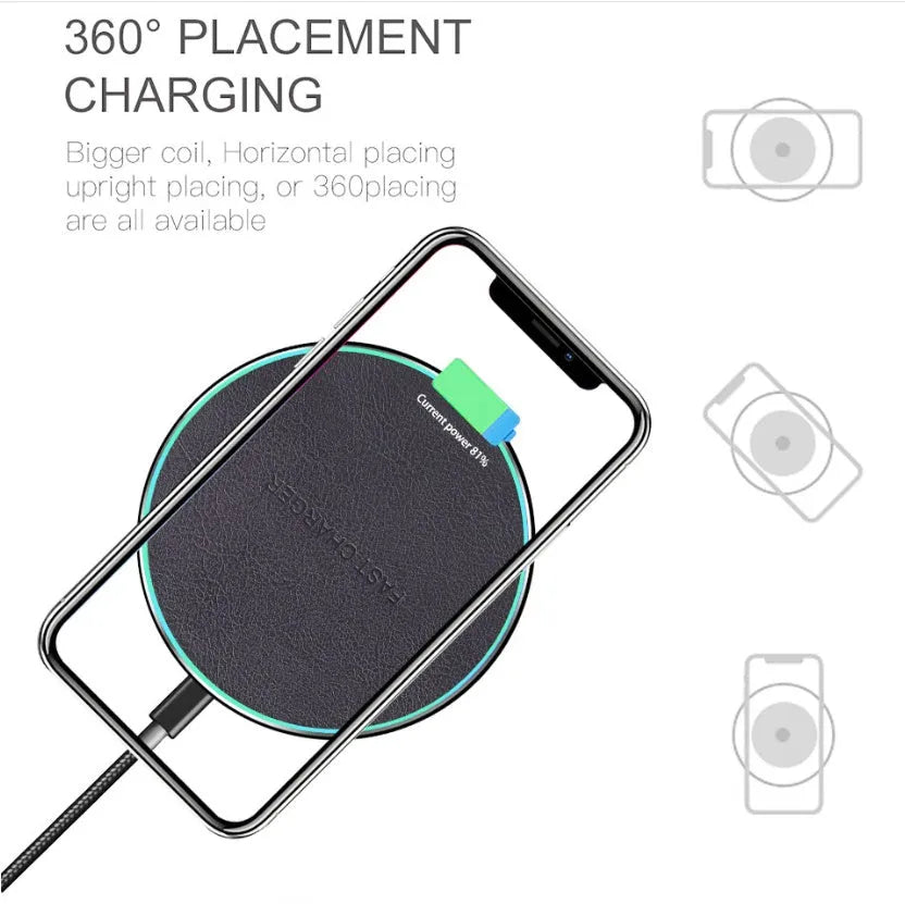 Black Quick Qi wireless charging pad on a desk, compatible with iPhone 11.
