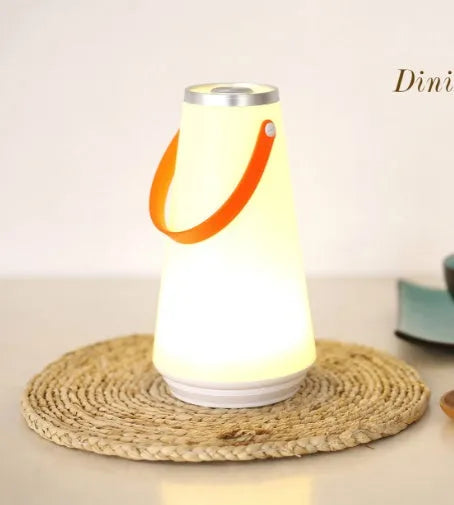 White rechargeable LED table lamp with adjustable brightness settings measuring 12x12x22cm