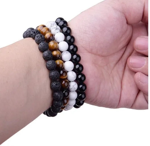 Black onyx bracelet with 8mm geometric agate beads on a black elastic cord.