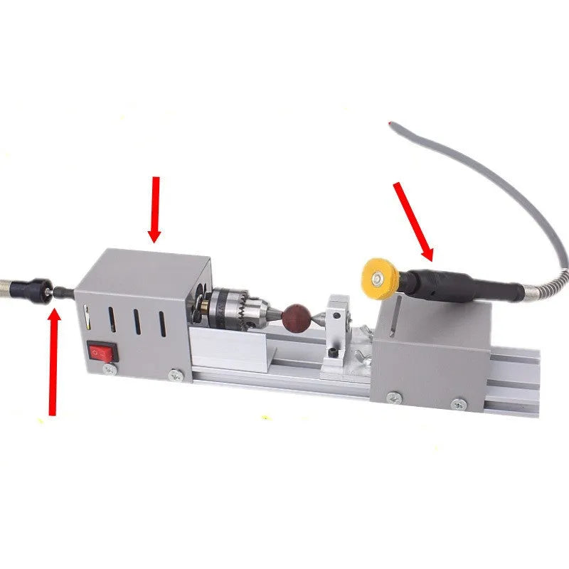 Silver metal mini woodworking lathe with carving knives on workbench