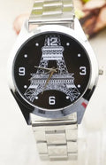 Silver Eiffel Tower wrist watch with leather strap on a wrist, showing detailed dial design.