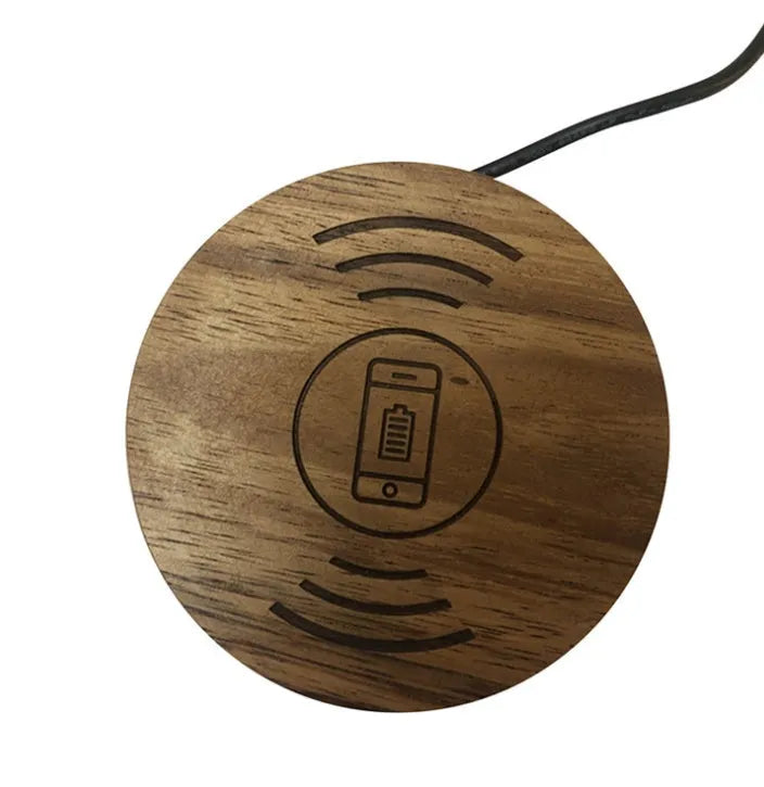 Black round 60mm diameter wireless phone charger for embedding into desk or table surface.