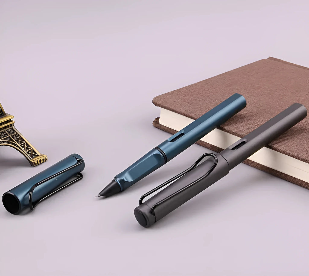 Black and blue frosted ink bag fountain pens with 0.38mm and 0.5mm nib options on a notebook.