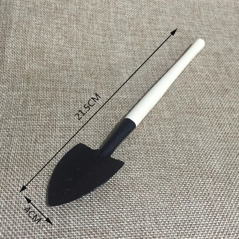 14-piece succulent gardening tool set showing watering can, tweezers, mini shovels, rake, and scissors on a table.