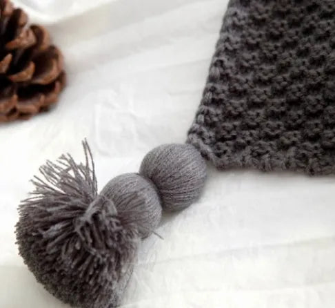 Nordic style fringed knit ball acrylic throw blanket in beige, laid flat showing 130x170cm size.