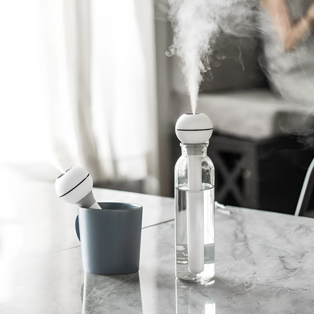 Columnar wand humidifier in pink or white with USB power cable and 1-litre water tank