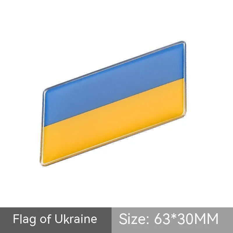 Aluminium national flag car sticker in a parallelogram shape measuring 6.3 by 3 centimetres.