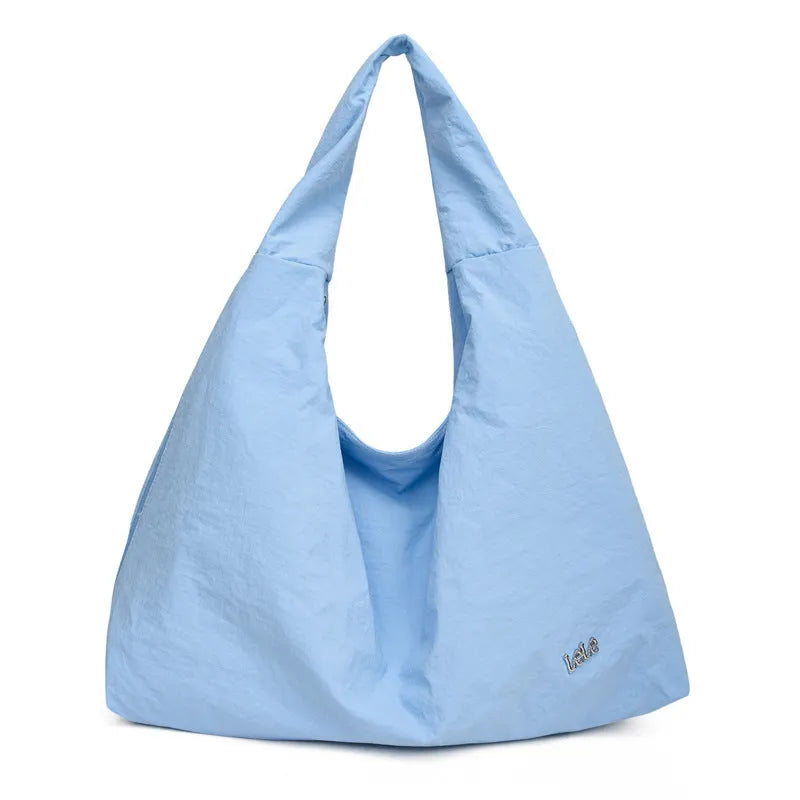 Soft heart-shaped nylon underarm bag for women in black, shown with a crossbody strap.
