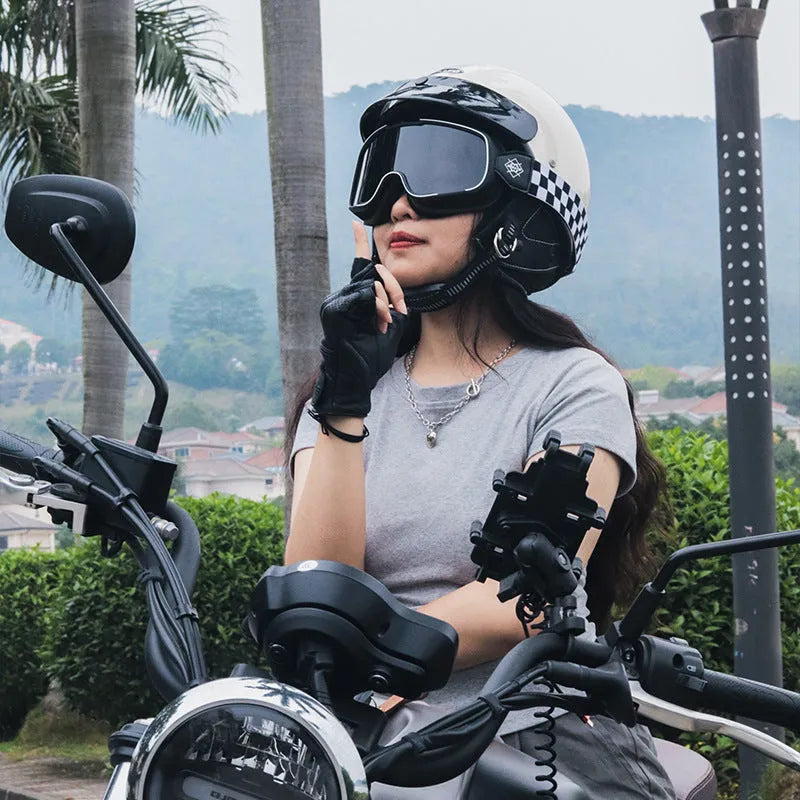 Retro-style motorcycle helmet in cement grey colour on a neutral background.