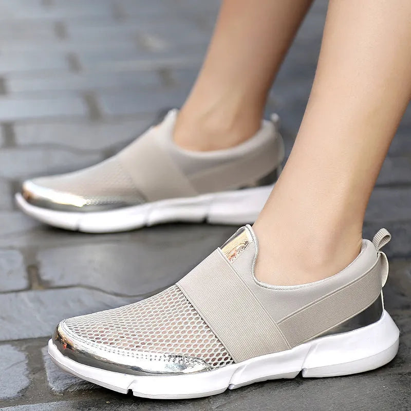 Women's low-cut casual sneakers in grey with mesh detail and PU midsole on a hard floor.