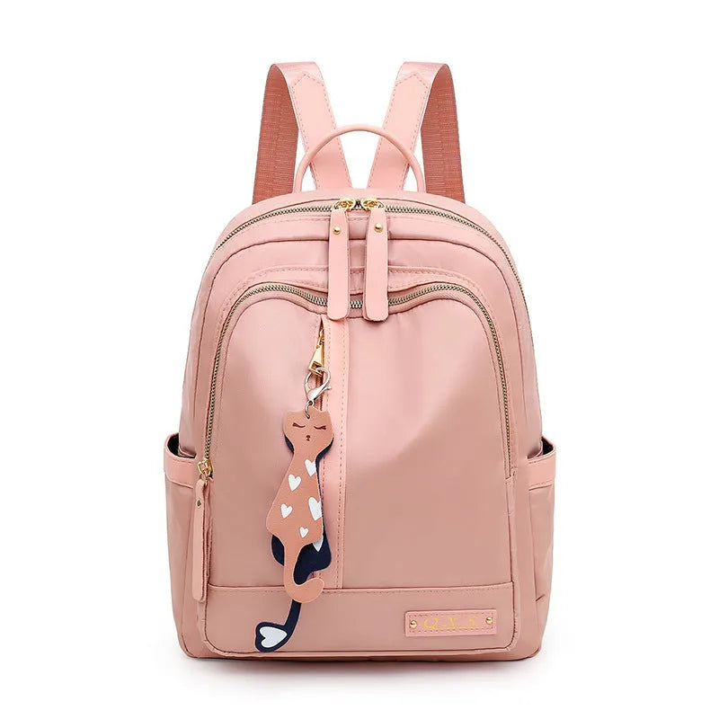 Women's black casual nylon backpack with double straps and a front pocket, shown next to a pink version.