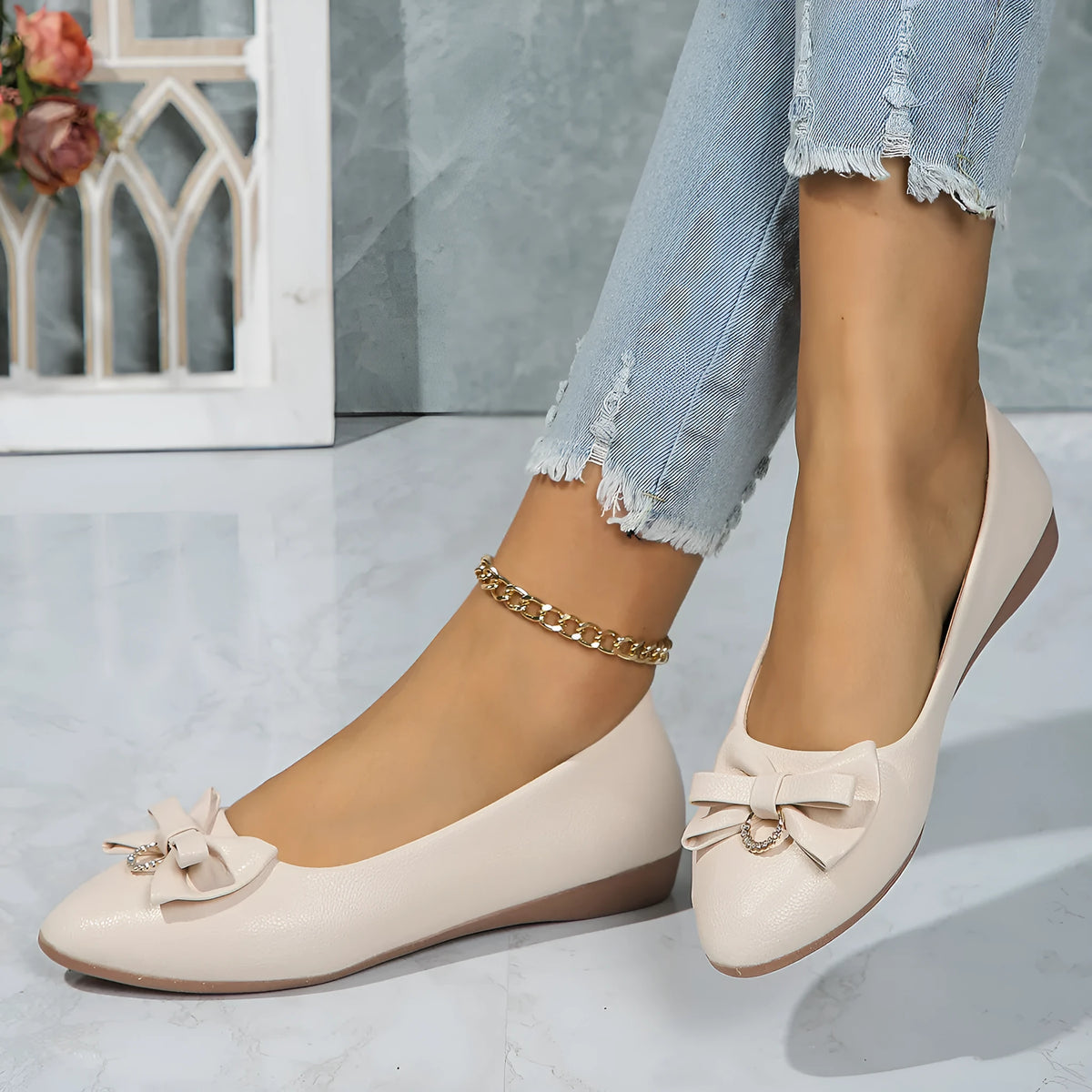 Women's beige casual flat slip-on shoe with a bowknot and round toe on a rubber sole.