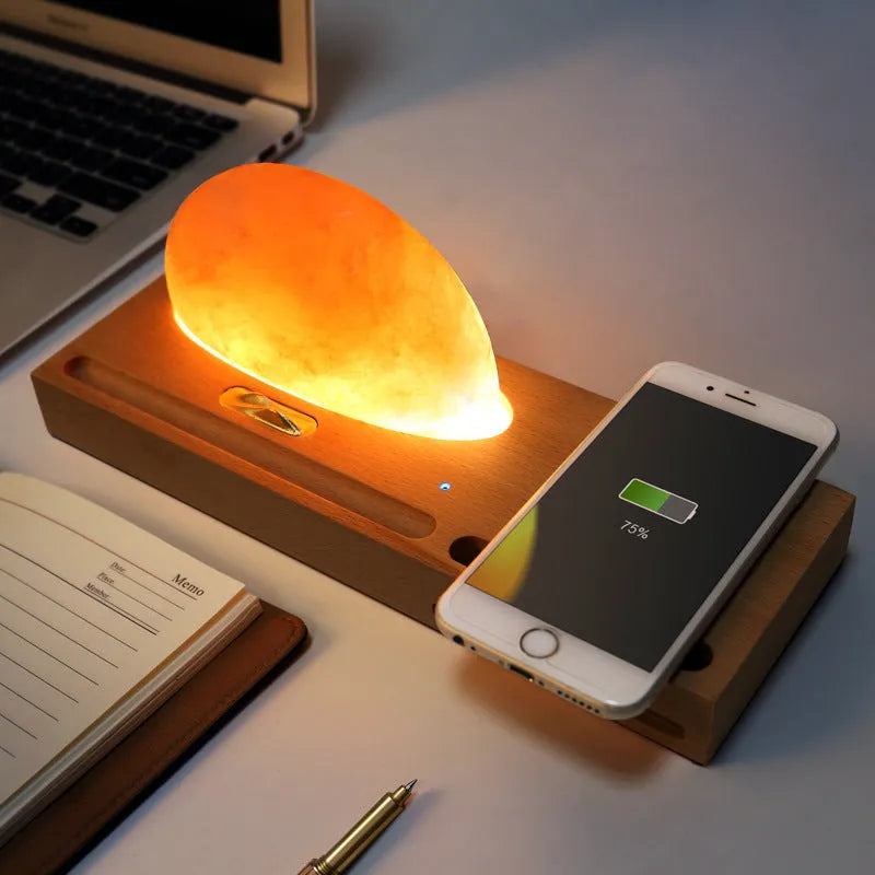 Natural crystal salt lamp with beech wood base featuring integrated wireless phone charging.