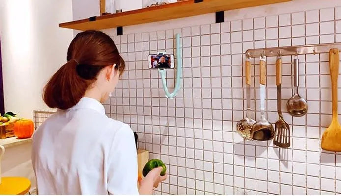Black flexible rubber phone holder with suction cup base and long worm arm extended.
