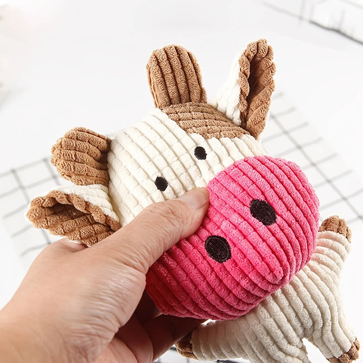 Animal-shaped plush dog chew toys with squeakers in blue, brown, grey, pink, white, and yellow colours