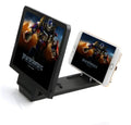 Black 3D screen amplifier mobile phone stand holding a smartphone on a table