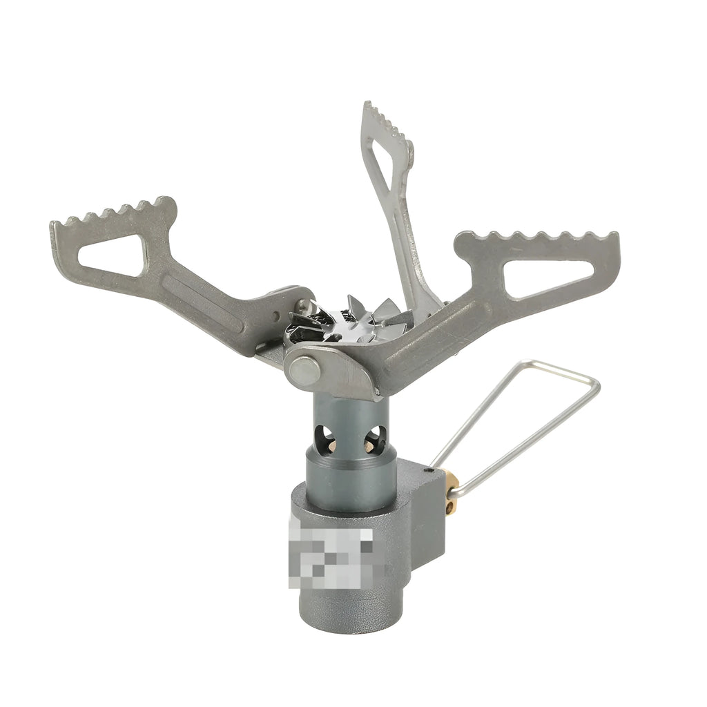 Portable camping gas stove with one-piece furnace on a rocky outdoor surface.