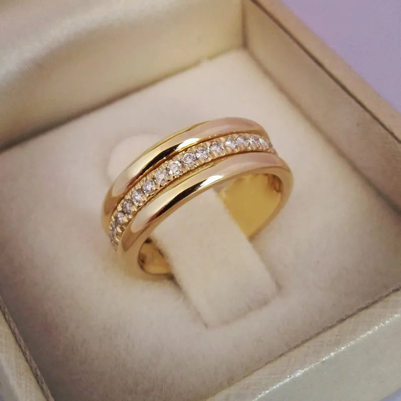Gold plated copper geometric ring with inlaid zircon stone on white background