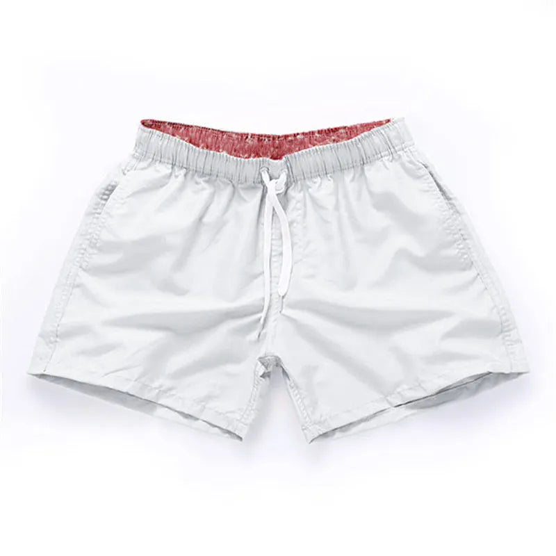 Men's polyester beach shorts in black, shown laid flat, featuring a straight leg opening.