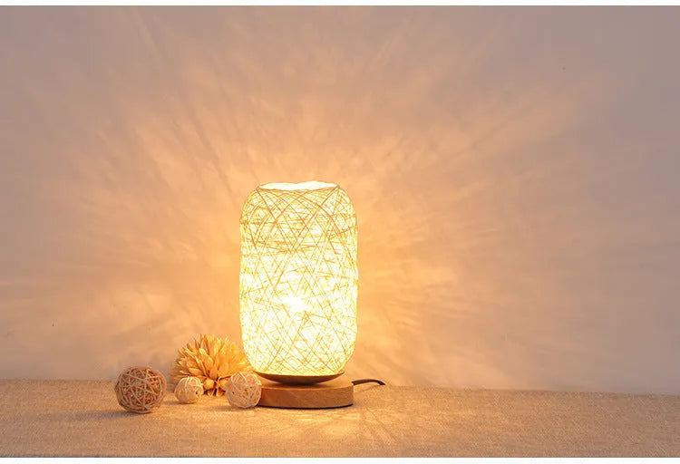 Brown hemp rope desk lamp with spherical shade on circular wood base