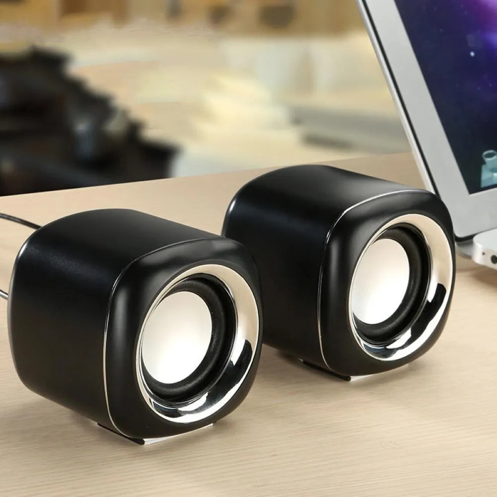 Pair of black cubic desktop speakers measuring 7.2cm with volume scroll wheel and 3.5mm cable