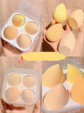Four makeup egg sponges in grape, mango, mint, and peach peach colours arranged in a box
