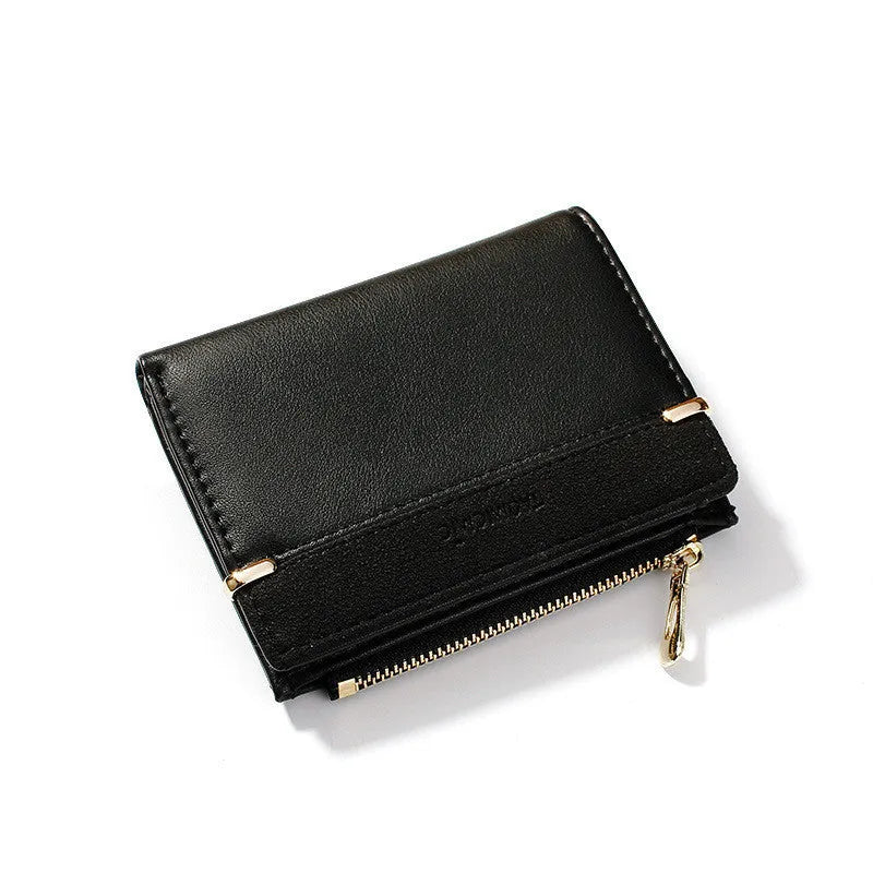 Women's black PU leather bifold wallet open to show card slots, zipper compartment, and change pocket.