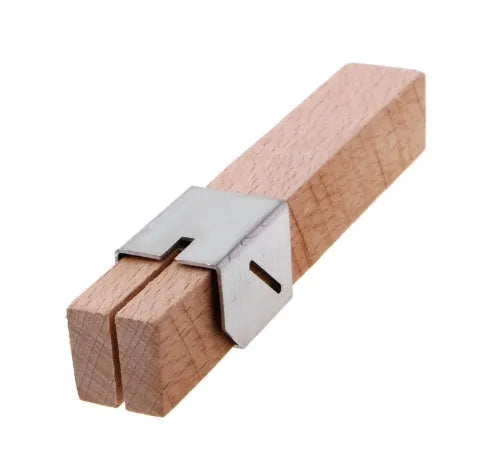 Plastic bottle cutter in log colour on a table showing its compact 2.2cm width and 14cm length