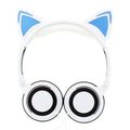 Black cat ear headphones with glowing pink LED lights on the ears and ear cushions.