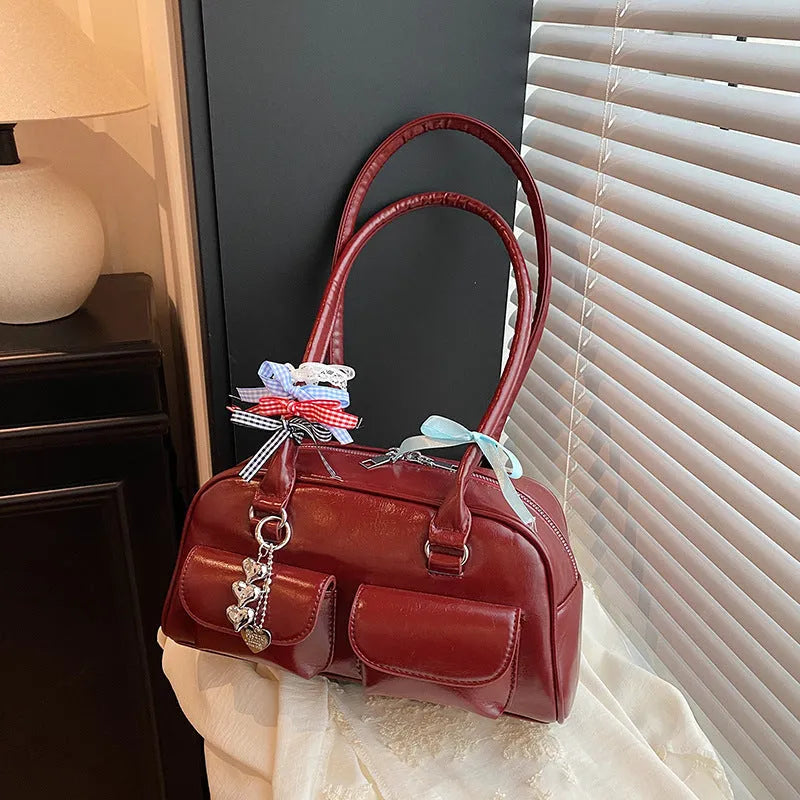 Women's black PU leather retro pillow handbag with flap closure and double shoulder straps.
