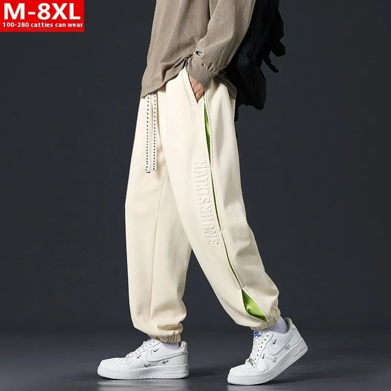 Men's loose-fit cotton trousers with stitching print design and ankle band in grey green.