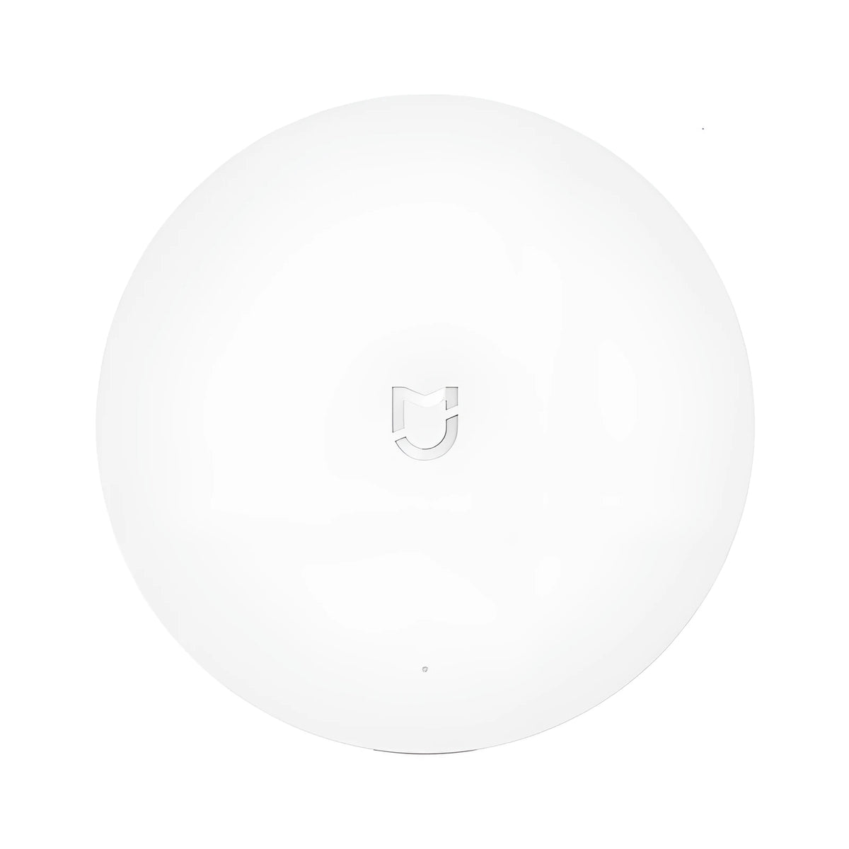 White circular Xiaomijia smart home gateway with UK plug for wall mounting.