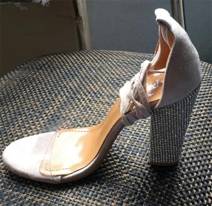 Black and gold plastic high heels with pointed toe design