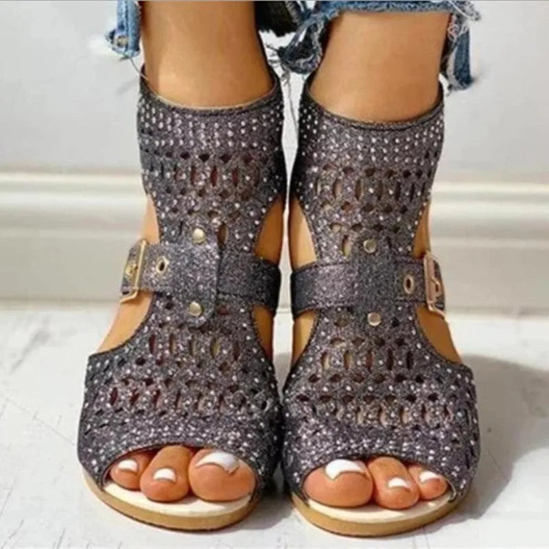 Women's beige flat sandals with a back zipper and low wedge heel.