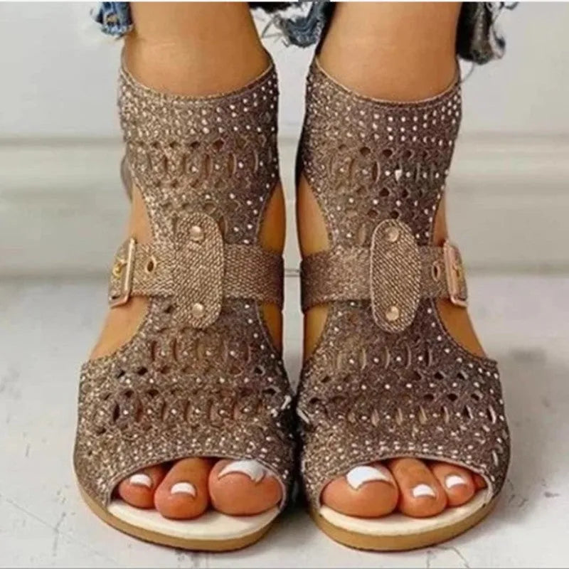 Women's beige flat sandals with a back zipper and low wedge heel.