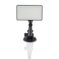 Black aluminium LED video conference light showing its slim profile and LED array, placed next to a laptop.