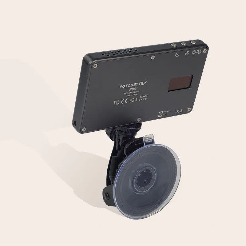 Black aluminium LED video conference light showing its slim profile and LED array, placed next to a laptop.