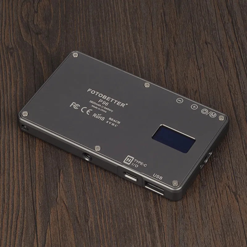 Black aluminium LED video conference light showing its slim profile and LED array, placed next to a laptop.