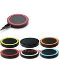 Square Qi wireless charging pad for mobile phones in six colour options on a wooden surface.